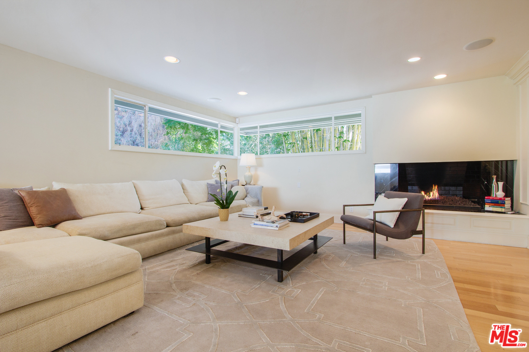 2267 Roscomare Road Los Angeles, CA 90077 - Photo 28 of 31 a living room with furniture and a flat screen tv