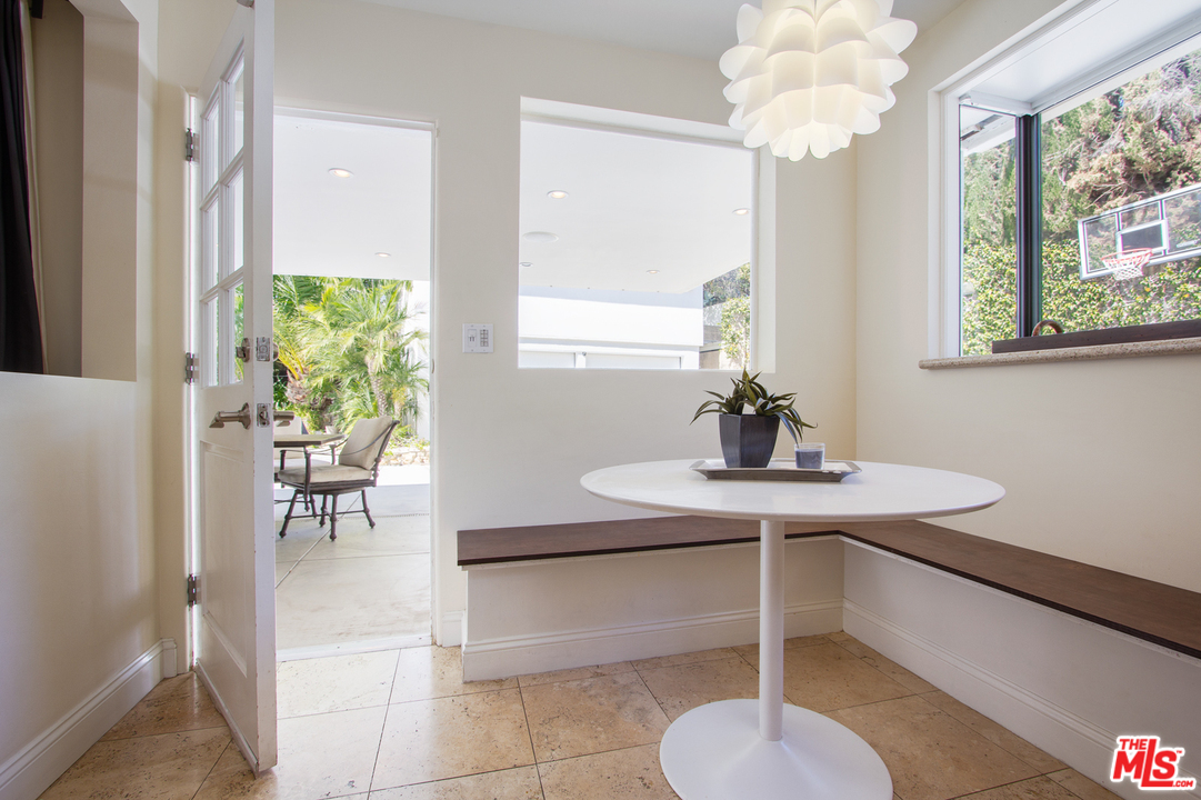 2267 Roscomare Road Los Angeles, CA 90077 - Photo 6 of 31 a dining room with chandelier and wooden floor