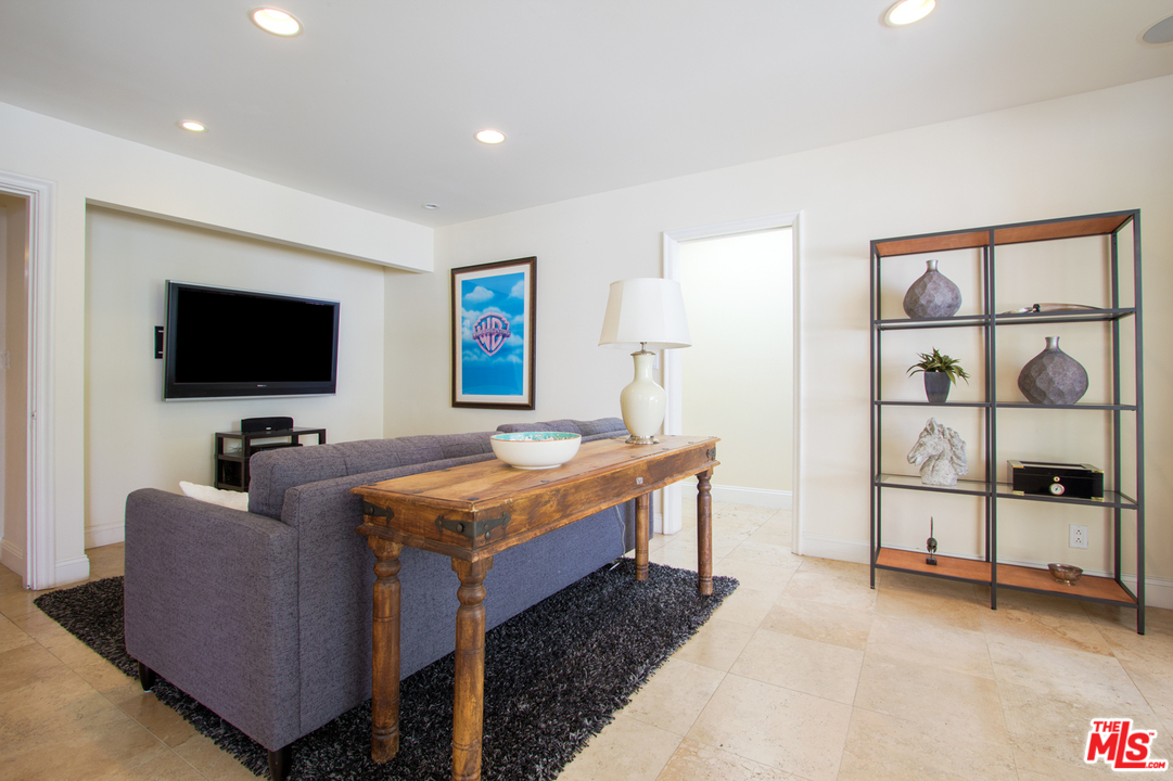 2267 Roscomare Road Los Angeles, CA 90077 - Photo 8 of 31 a living room with furniture and a flat screen tv