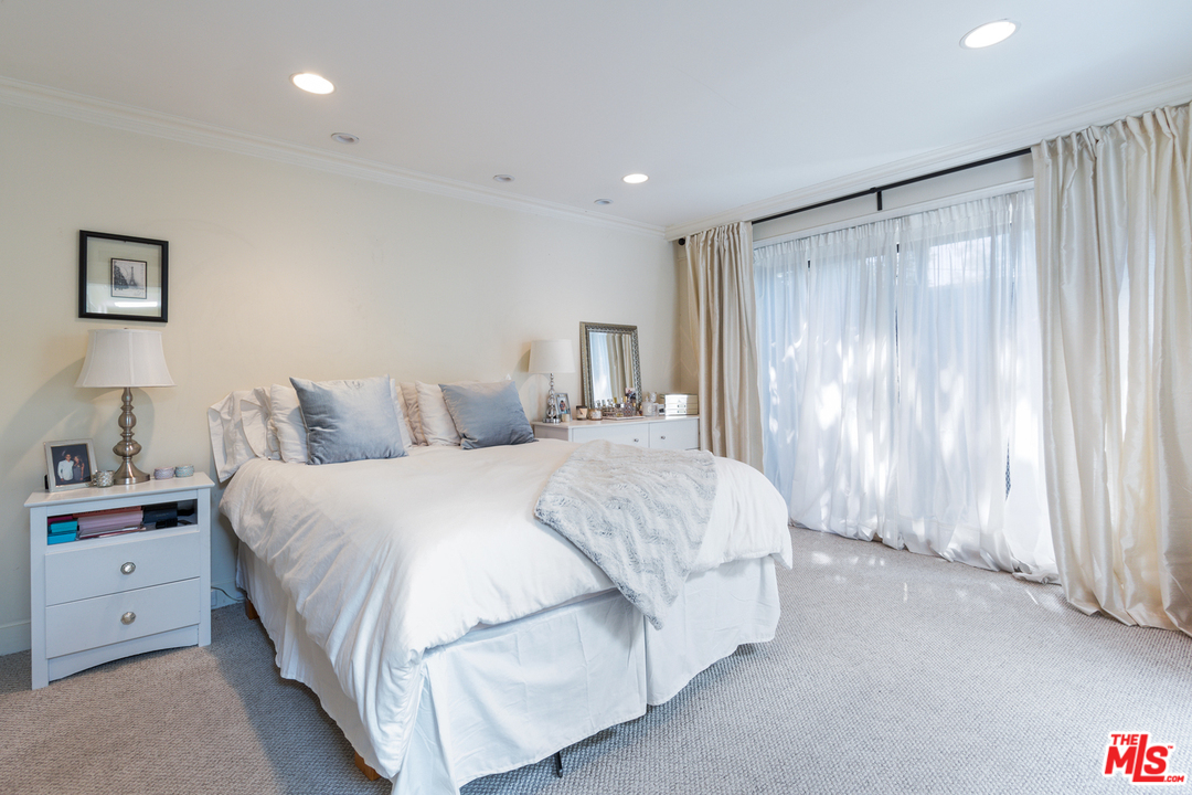 2267 Roscomare Road Los Angeles, CA 90077 - Photo 9 of 31 a bedroom with a large bed and a window