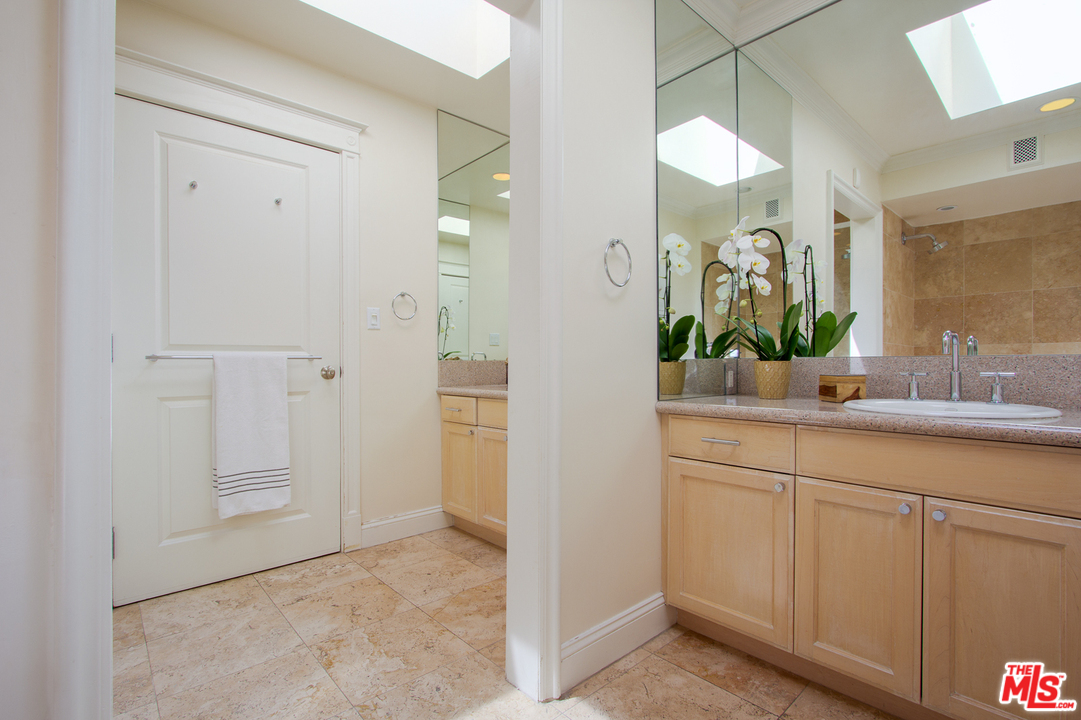 2267 Roscomare Road Los Angeles, CA 90077 - Photo 10 of 31 a bathroom with a sink and a mirror