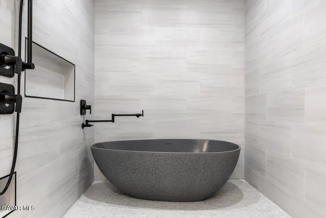 a white tub sitting in a bathroom