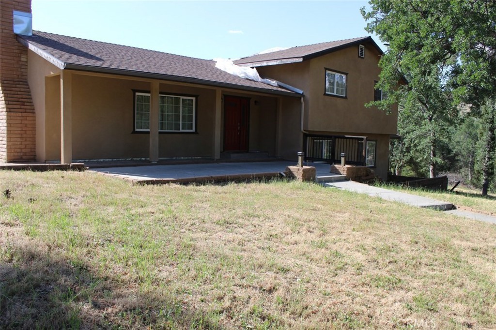 a house view with swimming pool in front of it