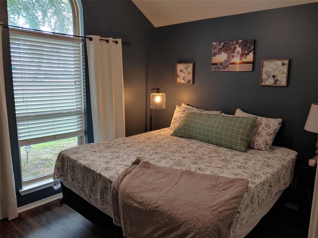 836 Airport Road Reno, TX 75462 - Photo 19 of 30 Arched window with horizontal blinds and white drapes
