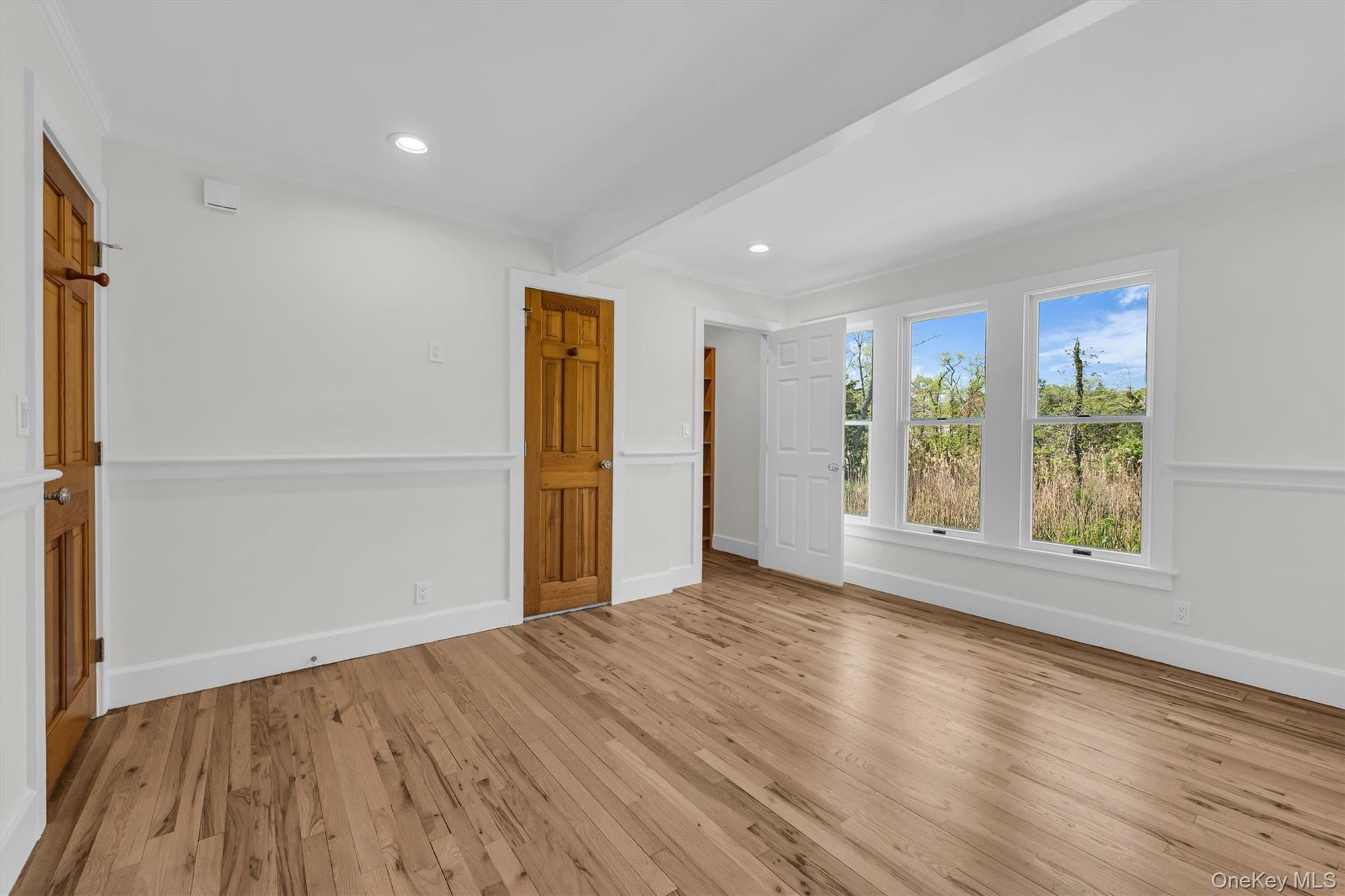 238 Beaver Dam Road Brookhaven, NY 11719 - Photo 29 of 44 a view of an empty room with wooden floor and a window