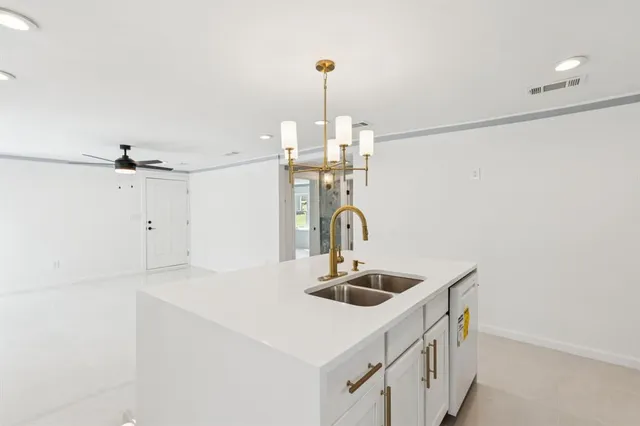 a kitchen with a sink and chandelier
