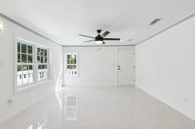 a view of empty room with ceiling fan