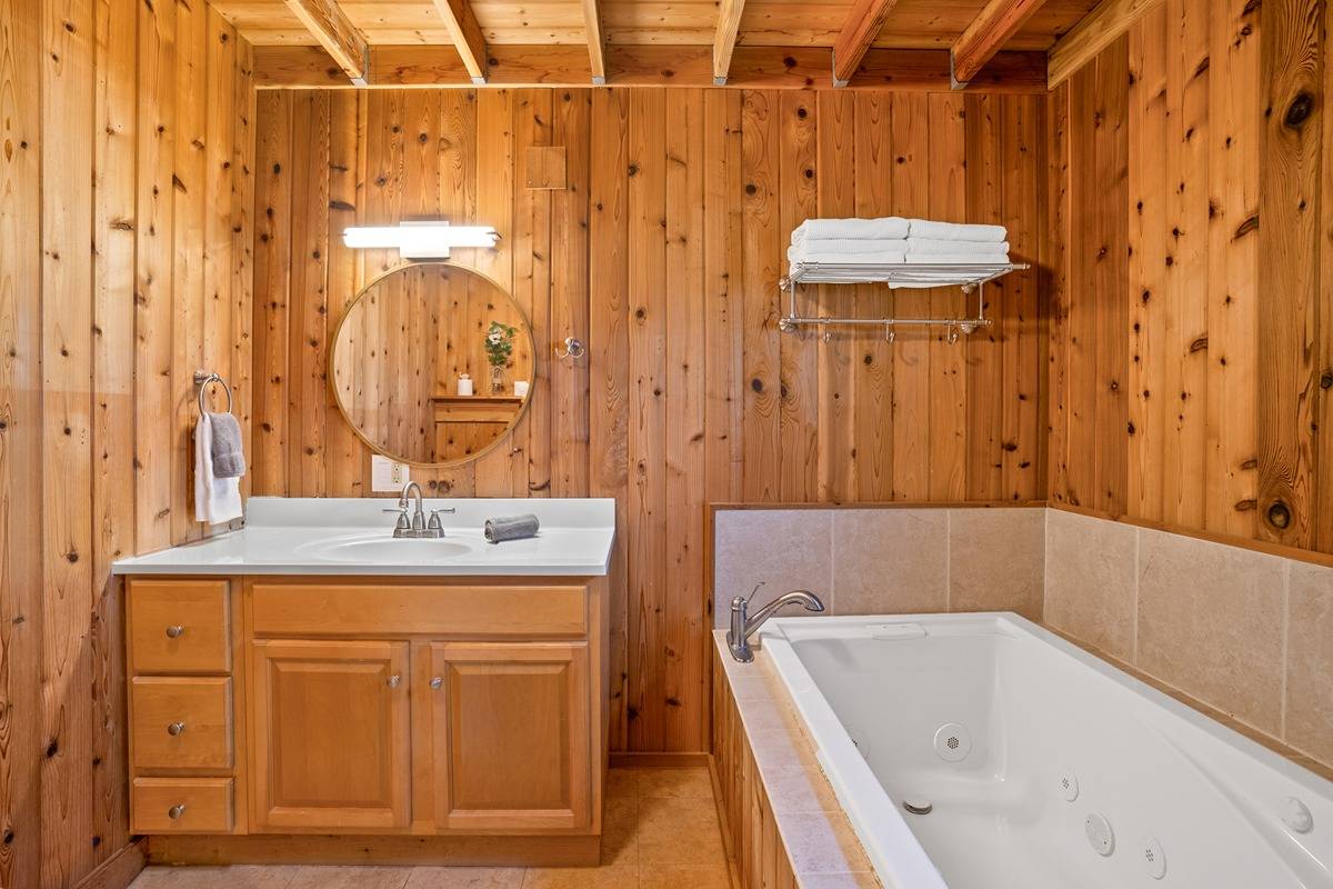 4875 A Hauaala Road, Unit 2 Kapaa, HI 96746 - Photo 14 of 30 a bathroom with a tub a sink and a large mirror