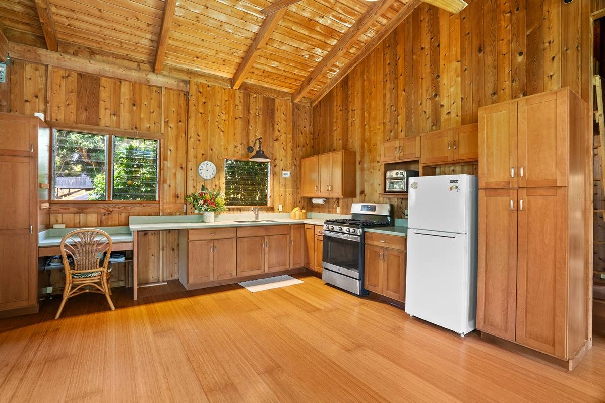 4875 A Hauaala Road, Unit 2 Kapaa, HI 96746 - Photo 8 of 30 a large kitchen with a large window a counter space and stainless steel appliances