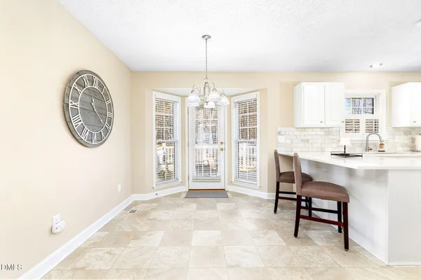 a kitchen with granite countertop white cabinets and white appliances
