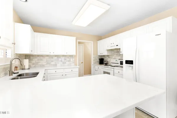 a kitchen with cabinets and appliances