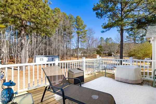 a view of a balcony with wooden fence and floor