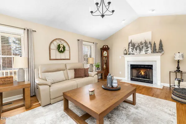 a living room with furniture a fireplace and a flat screen tv