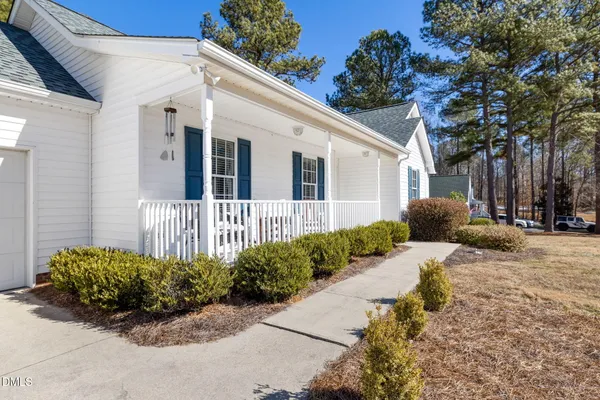 a view of a house with a yard and trees