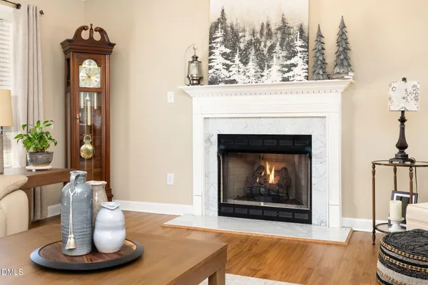 a living room with furniture a table and a fireplace