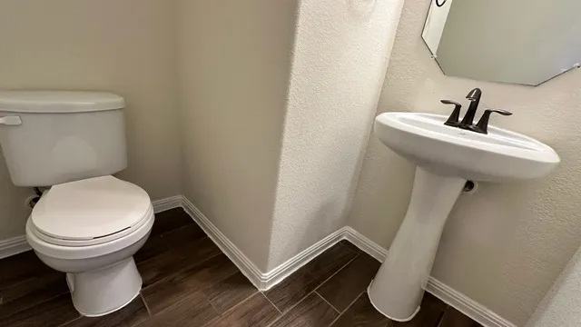 a view of kitchen with kitchen island wooden floor center island and stainless steel appliances