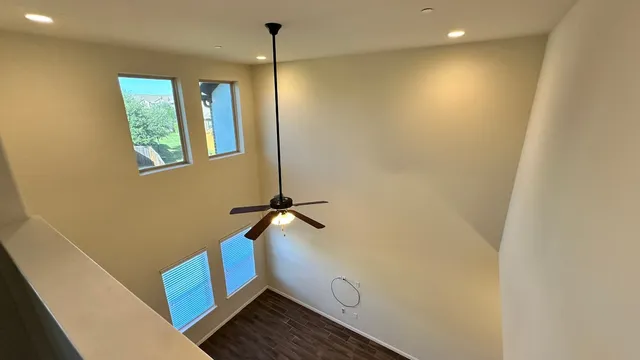 a view of kitchen with cabinets stainless steel appliances and wooden floor