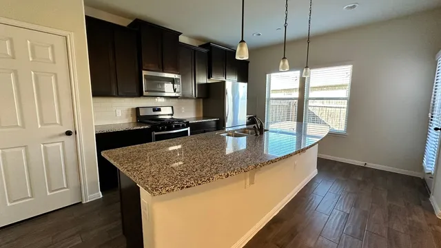 a view of entryway with wooden floor and stairs