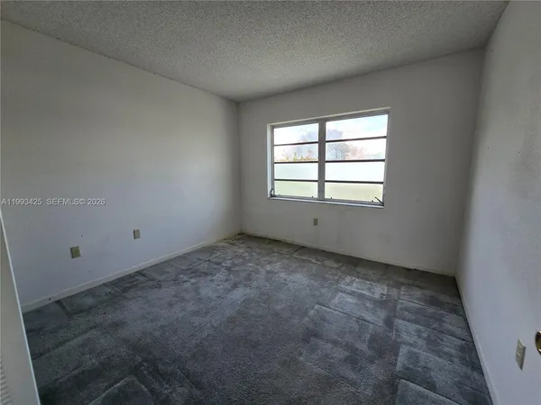 an empty room with a empty space and window