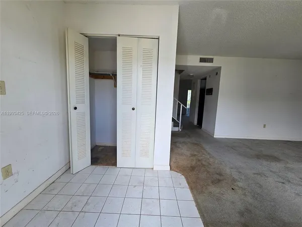 a view of a hallway to rooms