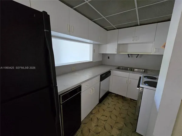 a kitchen with a sink stove and refrigerator