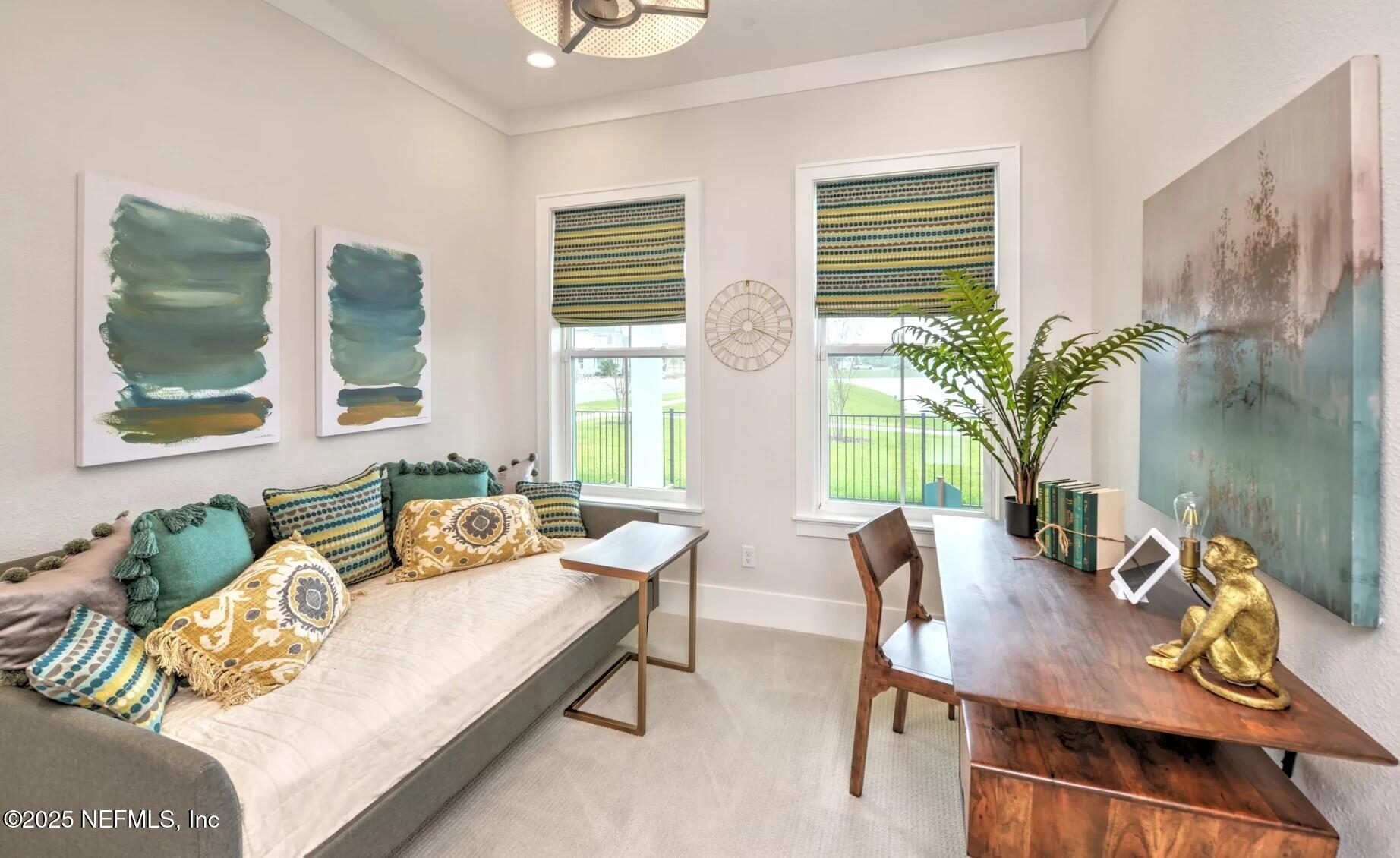 903 Someruelus Street Fernandina Beach, FL 32034 - Photo 11 of 31 a living room with furniture and a potted plant