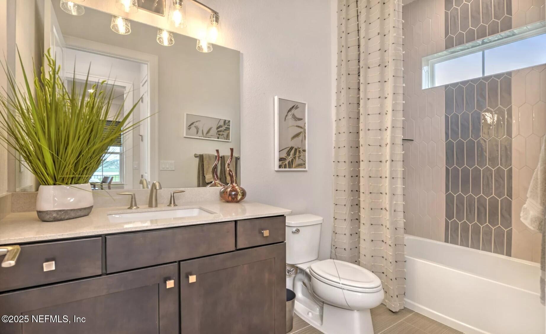 903 Someruelus Street Fernandina Beach, FL 32034 - Photo 12 of 31 a bathroom with a sink a toilet and shower