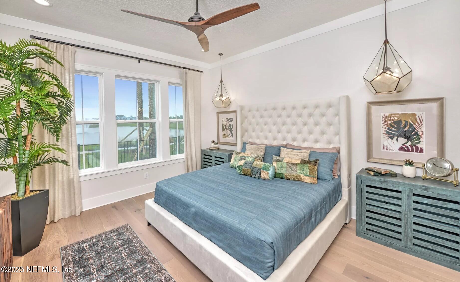 903 Someruelus Street Fernandina Beach, FL 32034 - Photo 13 of 31 a bedroom with a bed next to a window with outer view