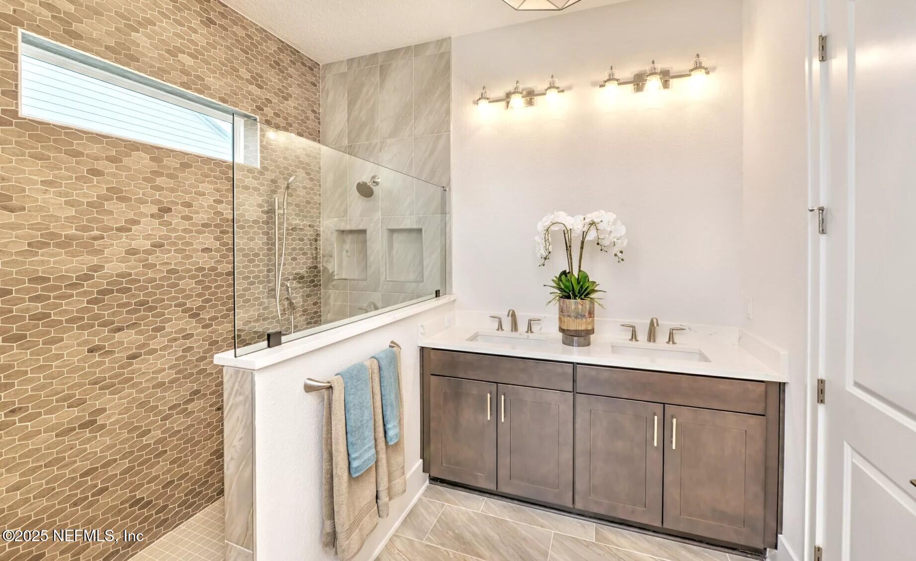 903 Someruelus Street Fernandina Beach, FL 32034 - Photo 14 of 31 a bathroom with a sink a mirror and a shower