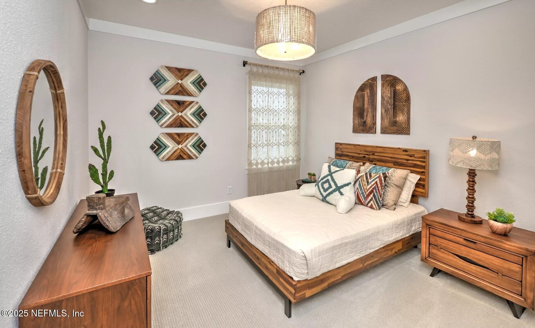 903 Someruelus Street Fernandina Beach, FL 32034 - Photo 16 of 31 a bedroom with a bed and a window