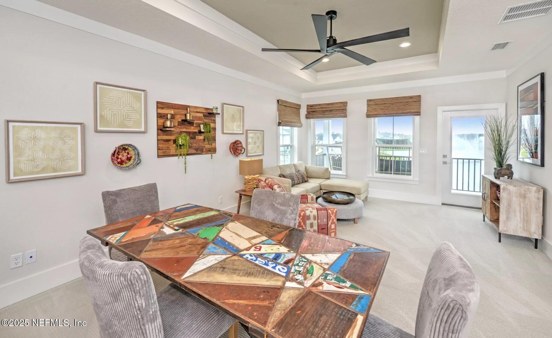 903 Someruelus Street Fernandina Beach, FL 32034 - Photo 17 of 31 a living room with furniture a chandelier and a table