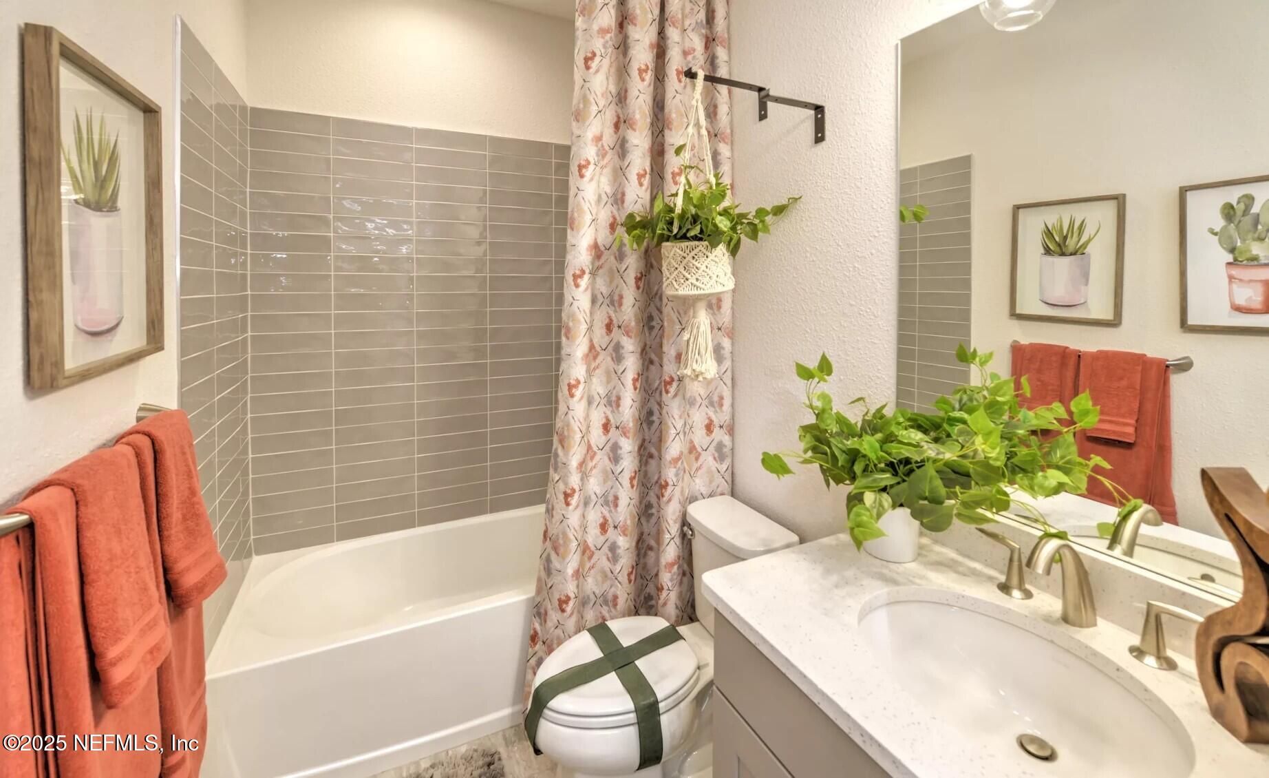 903 Someruelus Street Fernandina Beach, FL 32034 - Photo 18 of 31 a bathroom with a sink a bathtub and a sink