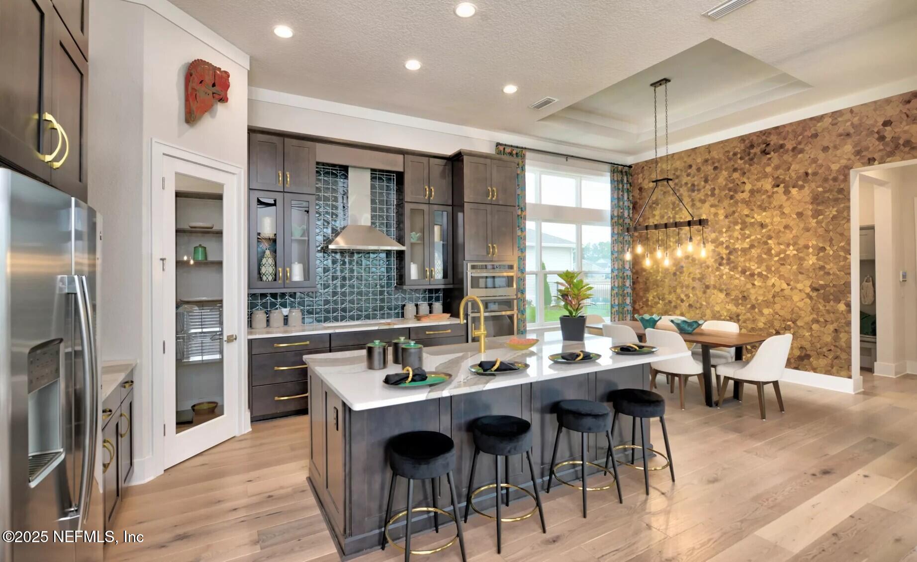 903 Someruelus Street Fernandina Beach, FL 32034 - Photo 4 of 31 a dining hall with stainless steel appliances kitchen island granite countertop a dining table and chairs