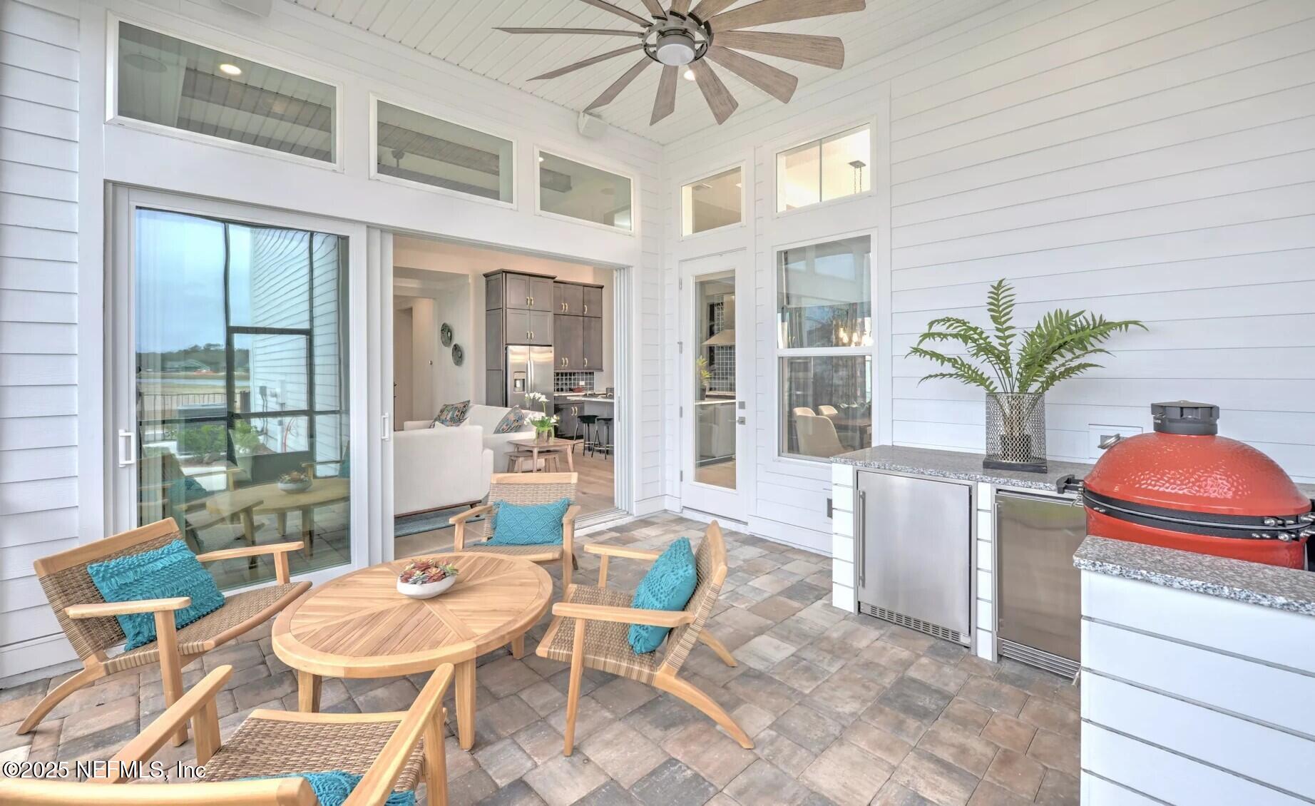 903 Someruelus Street Fernandina Beach, FL 32034 - Photo 9 of 31 a dining room with furniture a chandelier and a rug