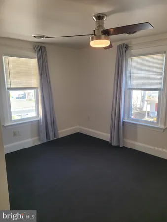 a view of a livingroom with an empty space and a window