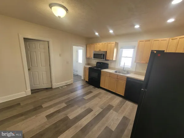 a kitchen with a refrigerator and a sink