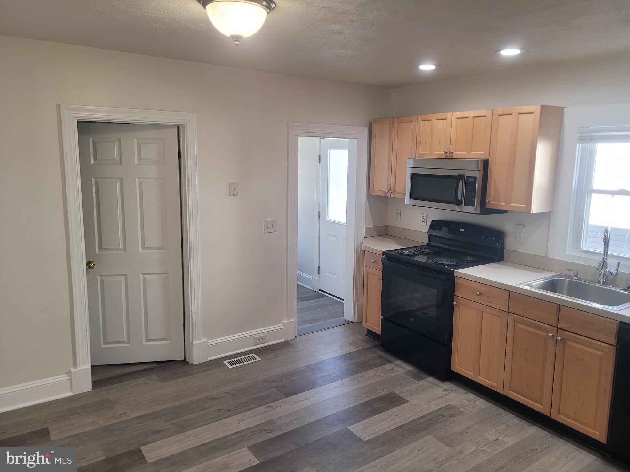 48 Webster Street Westminster, MD 21157 - Photo 6 of 25 a kitchen with a sink a microwave and cabinets