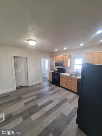 a view of kitchen and wooden floor