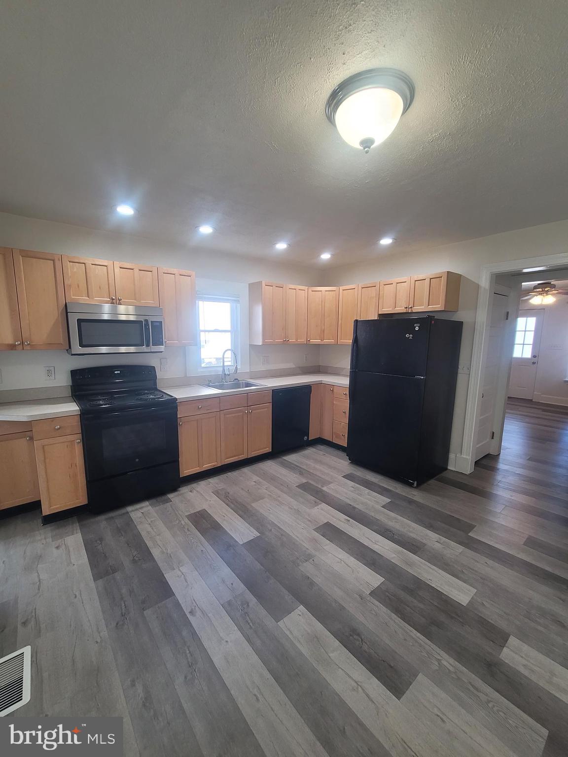 48 Webster Street Westminster, MD 21157 - Photo 9 of 25 a kitchen with stainless steel appliances kitchen island granite countertop a refrigerator and a stove top oven