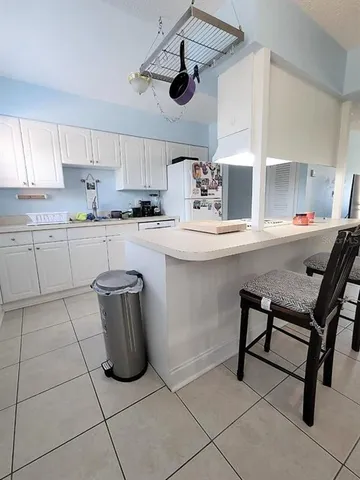 a kitchen with stainless steel appliances granite countertop a sink and a refrigerator