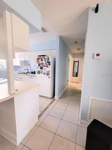 a kitchen with a refrigerator and a stove