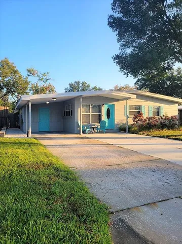 a front view of house with yard and green space