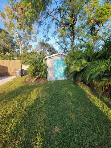 a view of green field with large tree