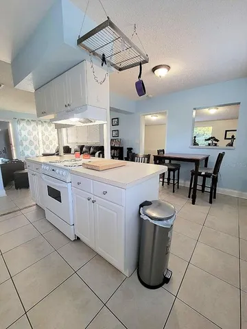 a kitchen with a stove a sink and cabinets
