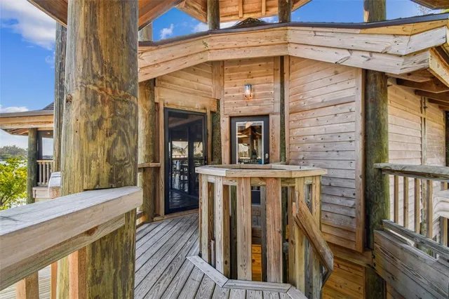 a view of a balcony with furniture and wooden floor
