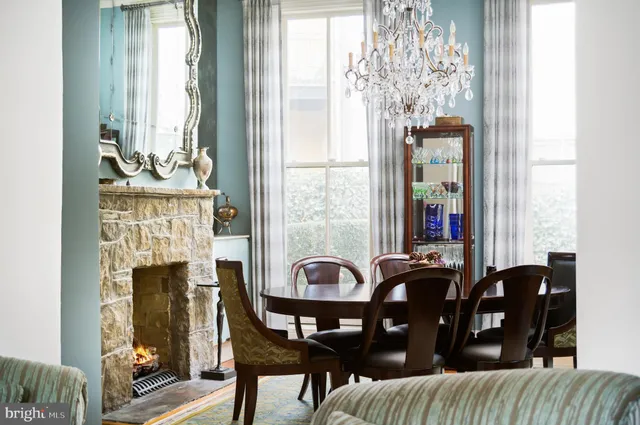 a view of a dining room with furniture and chandelier