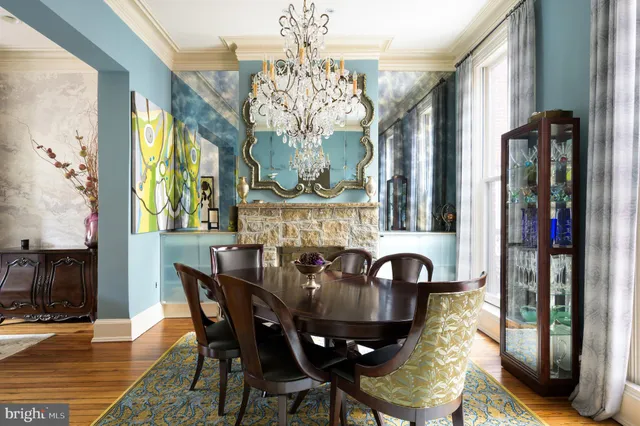 a view of a dining room with furniture and a chandelier