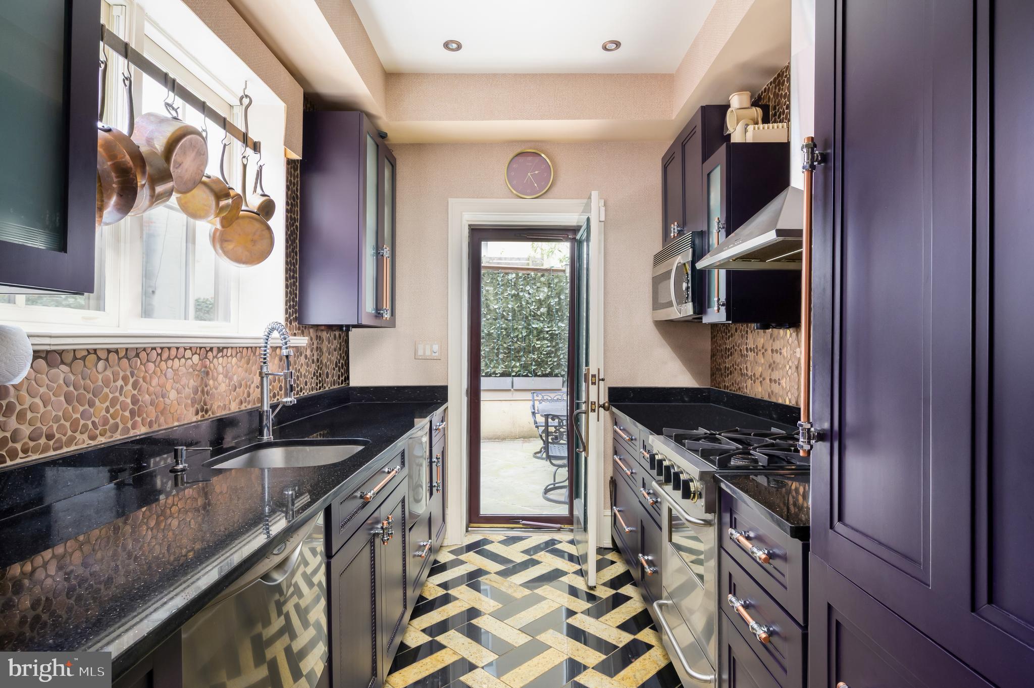 1335 Vermont Avenue Northwest Washington, DC 20005 - Photo 17 of 47 a kitchen with granite countertop a stove and a sink
