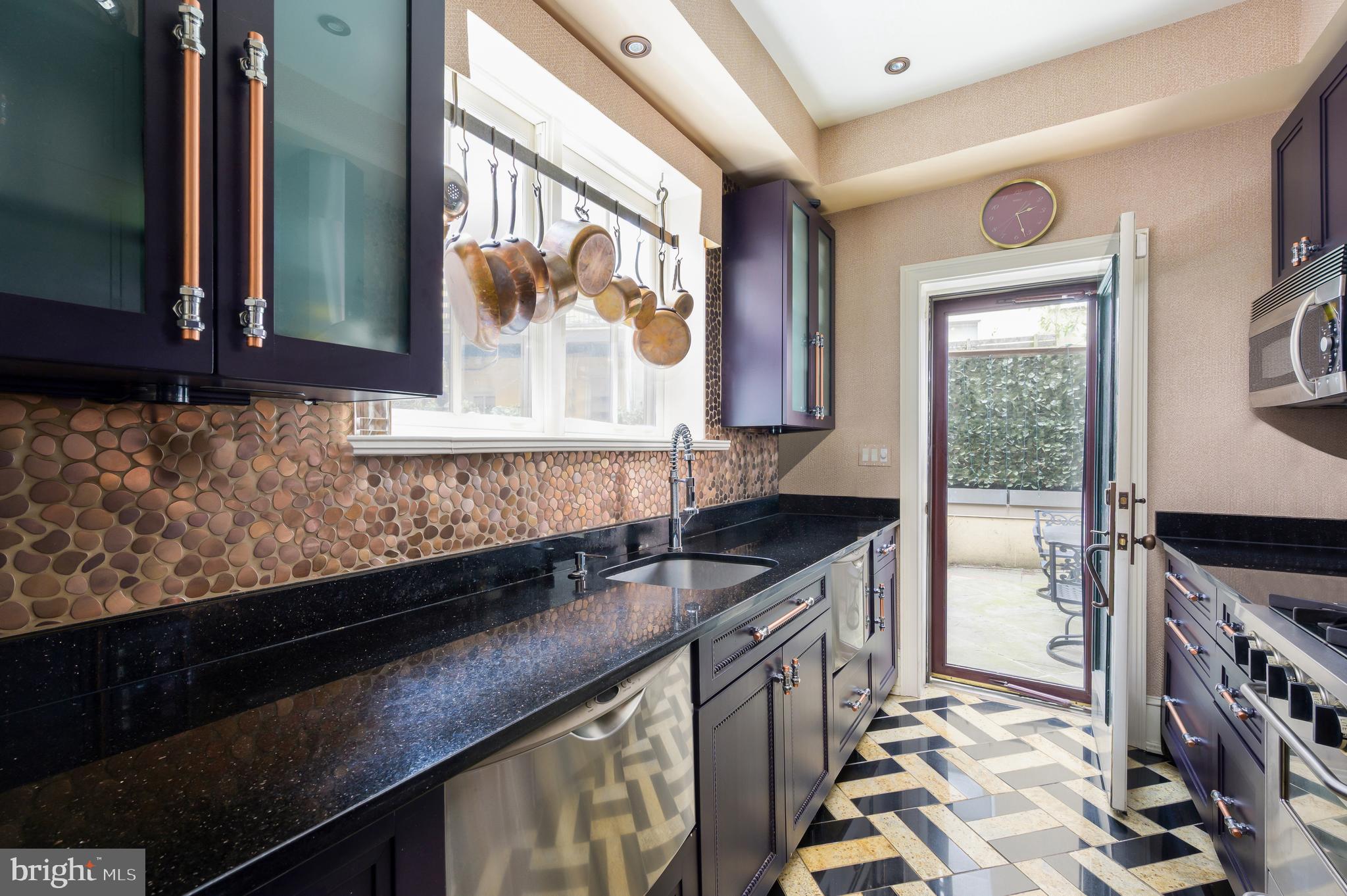 1335 Vermont Avenue Northwest Washington, DC 20005 - Photo 18 of 47 a kitchen with granite countertop a stove a sink and a microwave