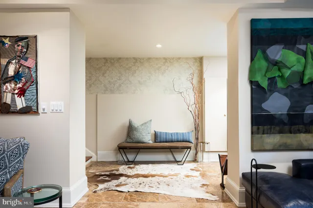 a living room with furniture a rug and a flat screen tv
